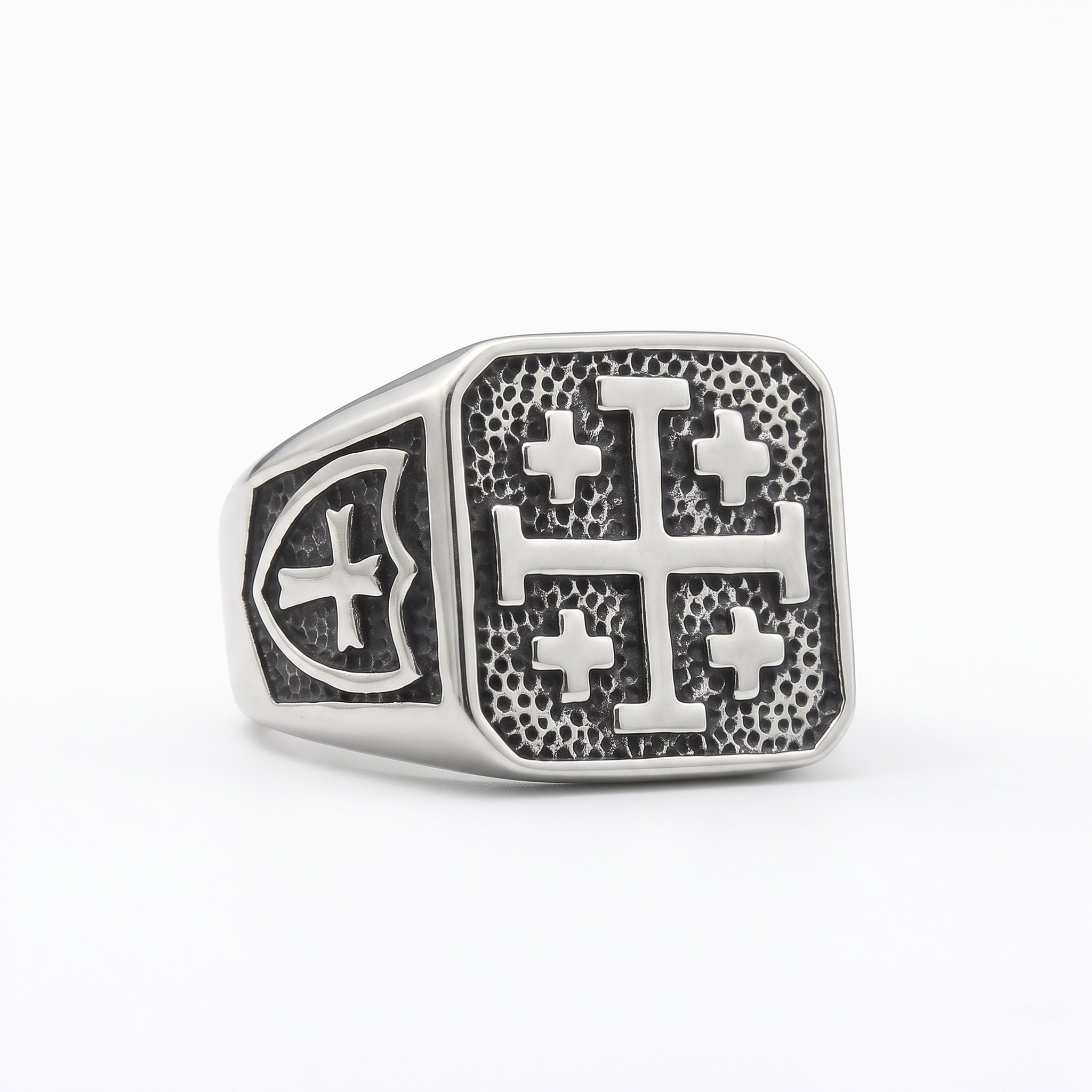 Jerusalem cross silver signet ring on white studio background