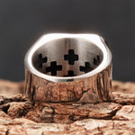 Inside view of the Jerusalem Cross signet ring, showing cross-shaped cutouts and the polished stainless steel band