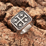 Jerusalem Cross men’s signet ring in stainless steel, angled top view of the cross design on a hammered black face