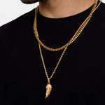 Man wearing 18K gold plated angel wing necklace layered with gold cuban chain, black t-shirt