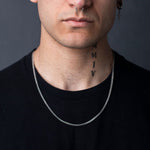 Man wearing 2mm sterling silver Franco chain necklace over black shirt