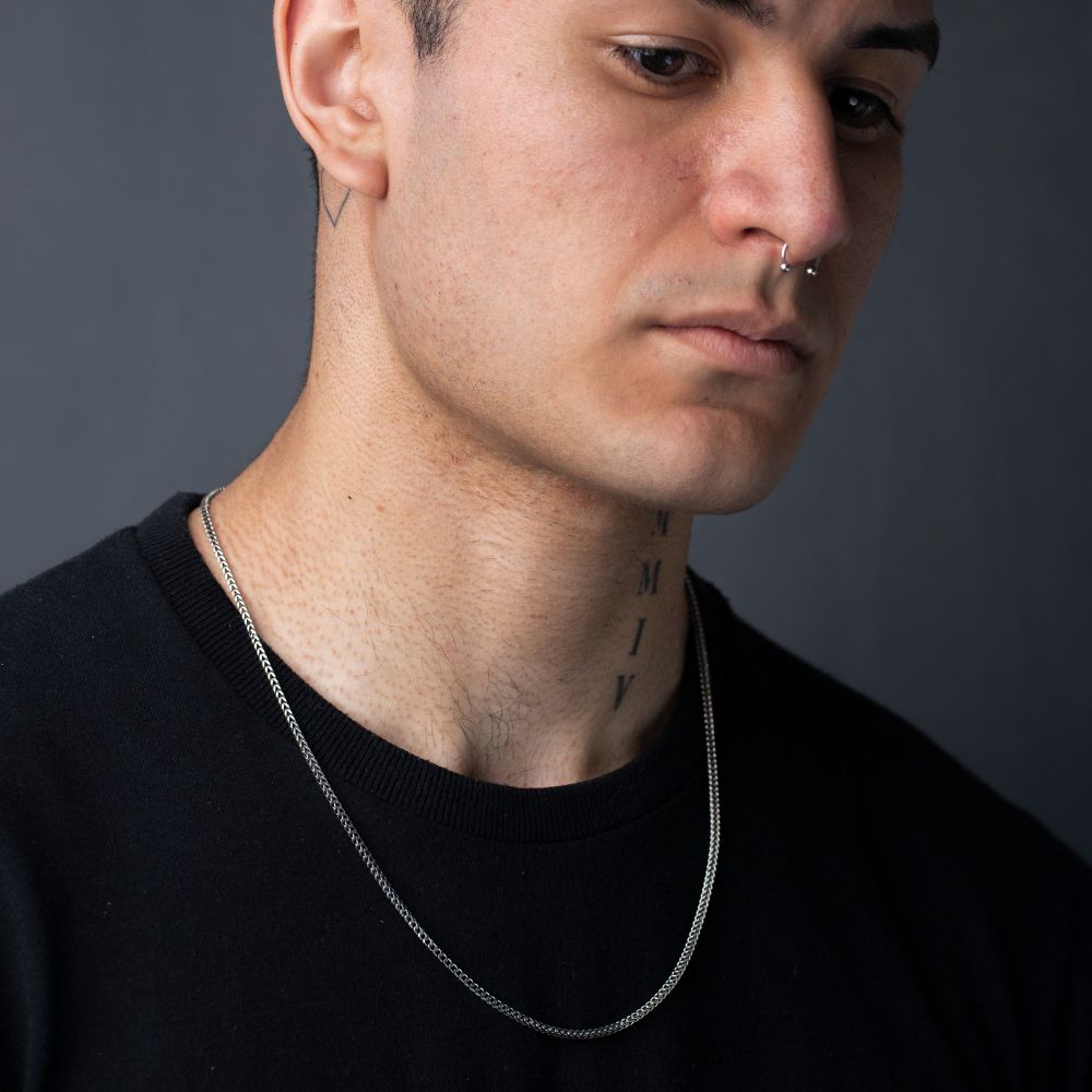 Side profile of man wearing 925 silver Franco chain necklace