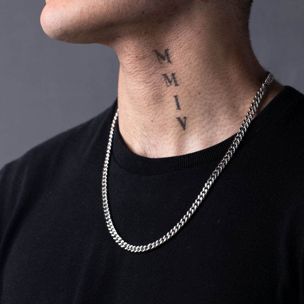 Man wearing sterling silver Cuban link chain necklace over black t-shirt