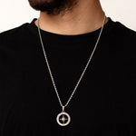 Silver necklace with a north star compass pendant on a black shirt