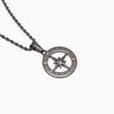 Silver North Star compass pendant on a chain against a white background