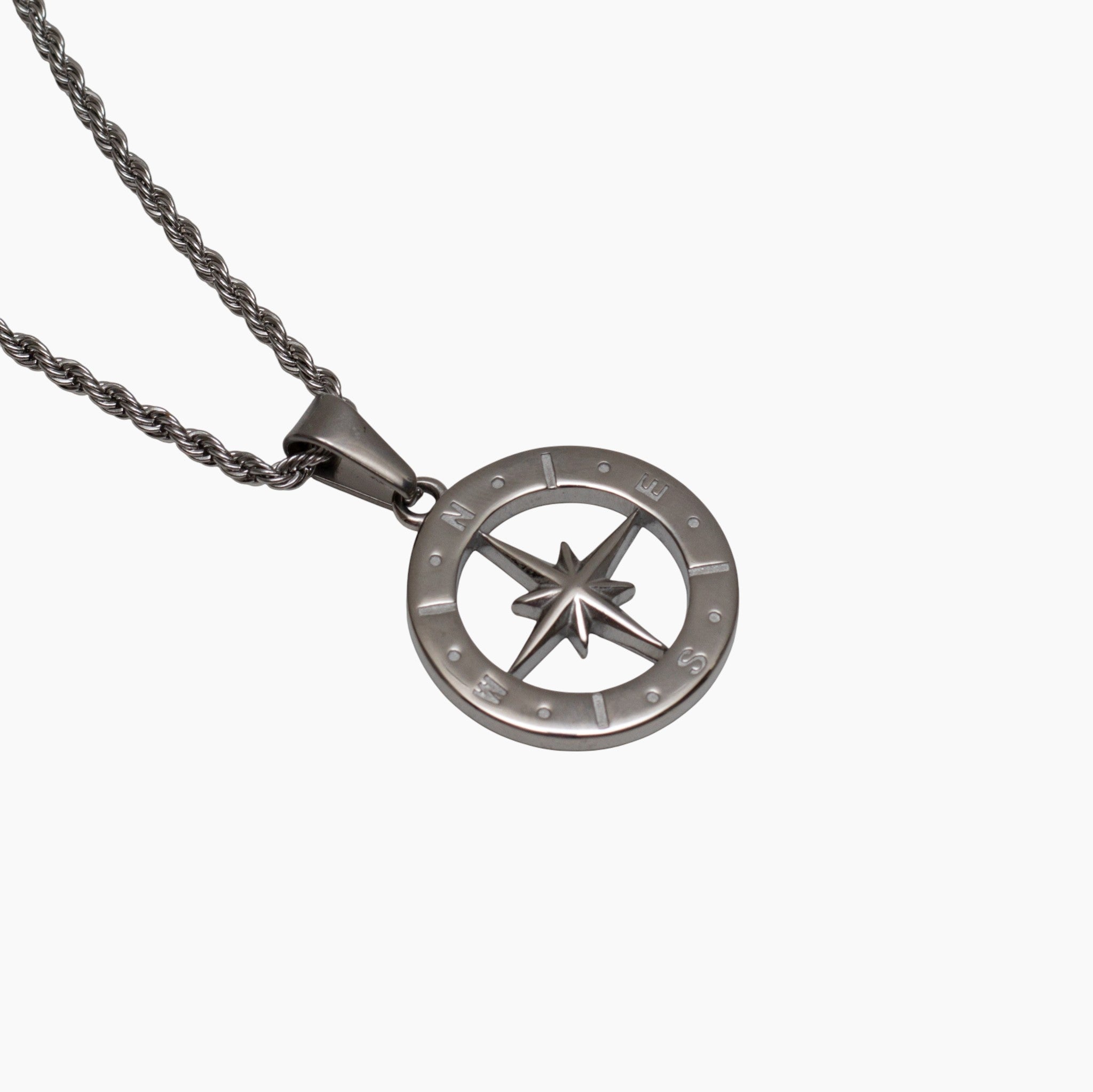 Silver North Star compass pendant on a chain against a white background