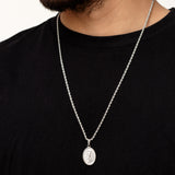 Silver St. Michael necklace with a pendant on a black shirt