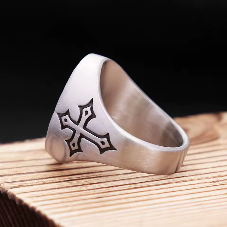 Side view of the men’s stainless steel Sacred Heart ring, showing the engraved cross on the band and brushed finish