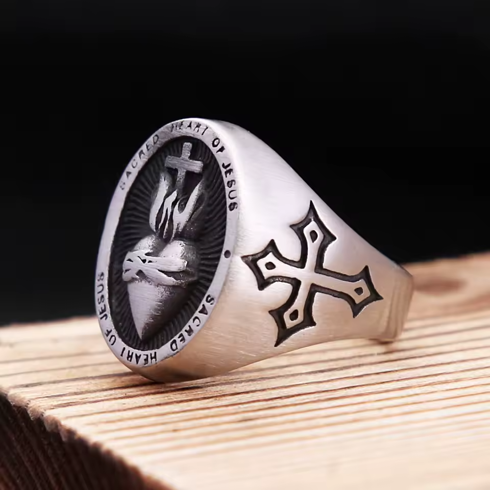 Angled view of the Sacred Heart of Jesus signet ring for men, showing the oval face and engraved side cross