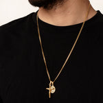 Gold necklace with a pendant on a black shirt