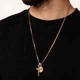 Gold necklace with a pendant on a black shirt