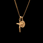 Gold necklace with a crucifix pendant on a black background