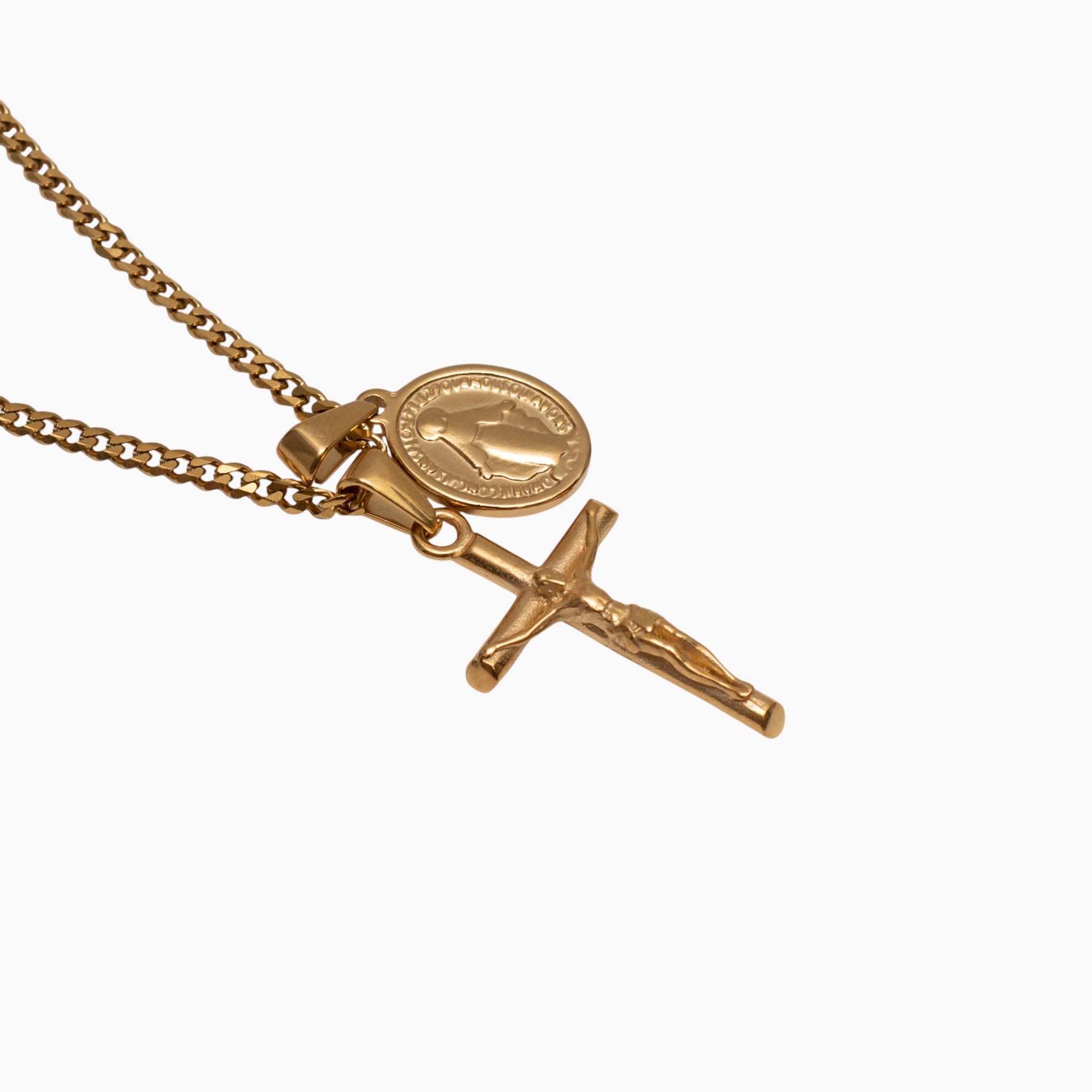 Gold necklace with a cross and round pendant on a white background
