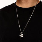 Silver necklace with a cross pendant on a black shirt