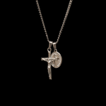 Silver necklace with a crucifix pendant on a black background